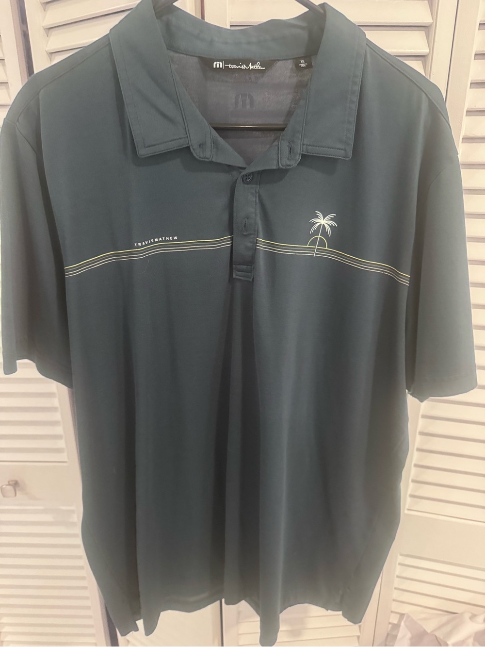 Travis Mathew Dark Teal Polo with Palm Tree Graphic
